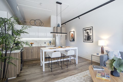 a kitchen and dining area with a white table and chairs