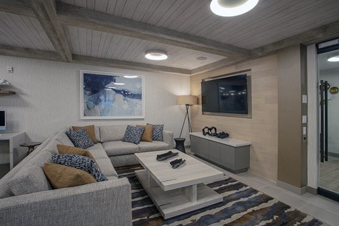 A living room with a grey couch and a white coffee table.