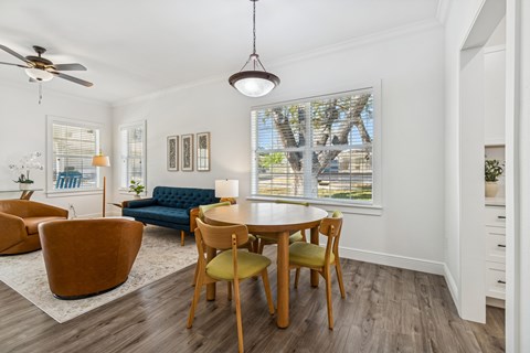 A dining room with a table and chairs.