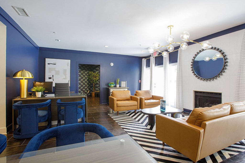 A living room with a fireplace and a striped rug.