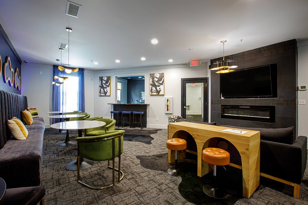 A room with a bar and a pool table.