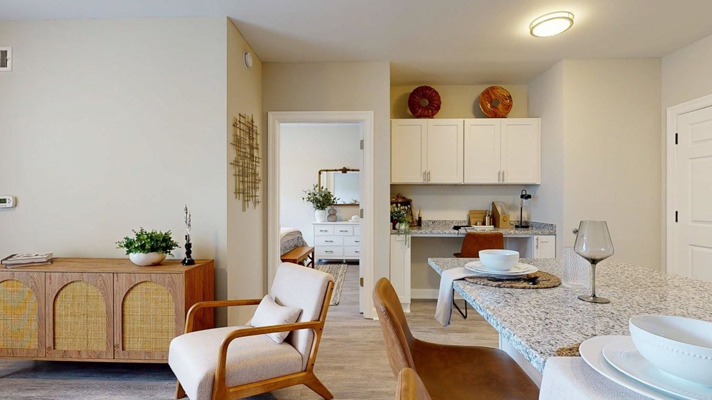 A dining room with a table set for two and a chair.