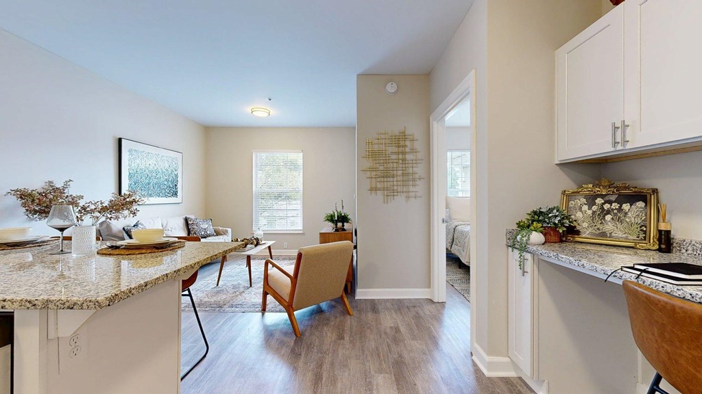 A kitchen with a dining table and chairs in the middle of the room.