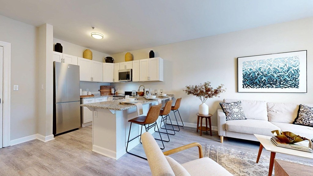A modern kitchen with a dining table and chairs.