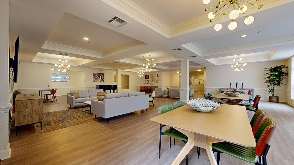 A large room with a long table and chairs.