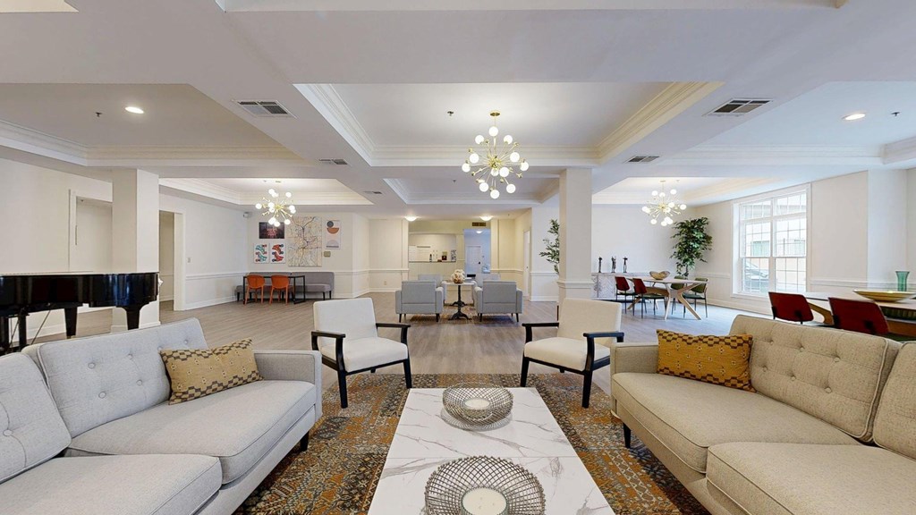 A living room with a piano and a white couch.