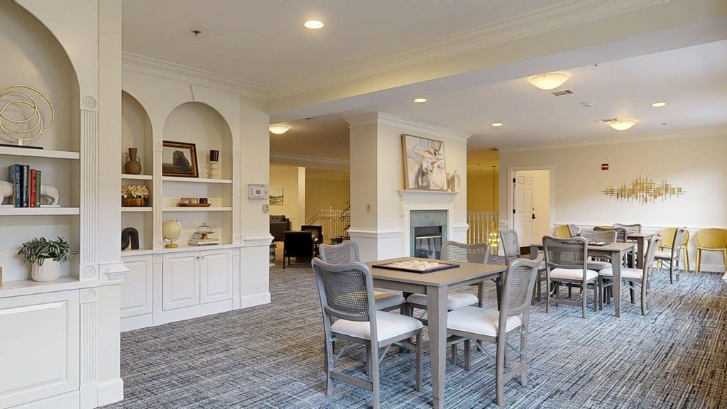 A dining room with a grey table and chairs.