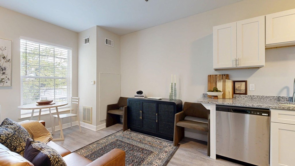 A kitchen with a dining table and chairs is shown.