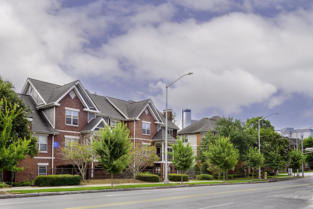 A street view of a residential area with apartment buildings.
