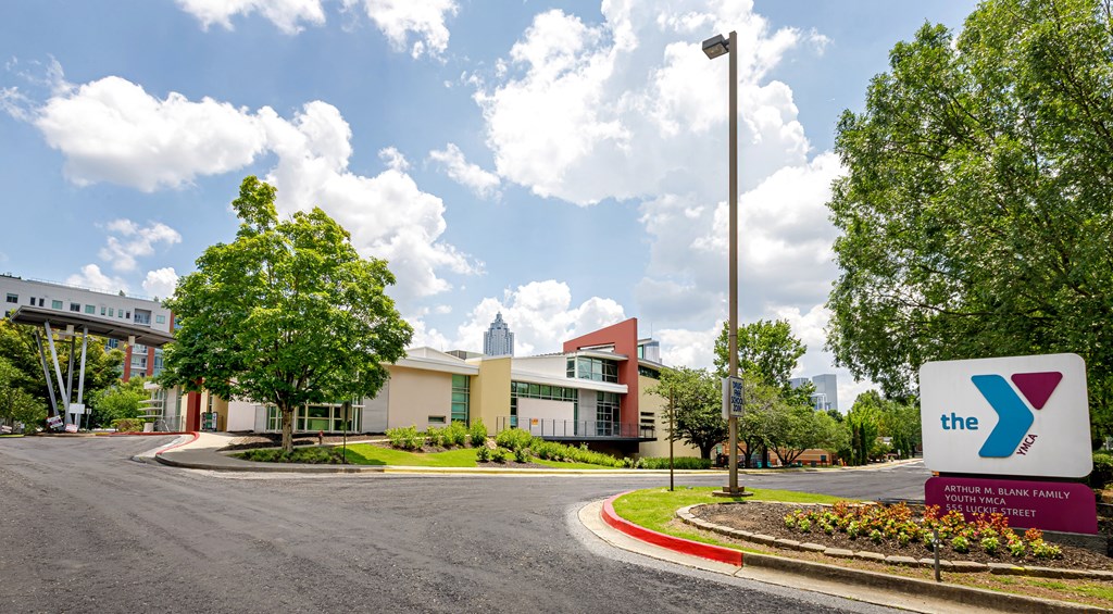 The YMCA logo is on a sign in front of a building.