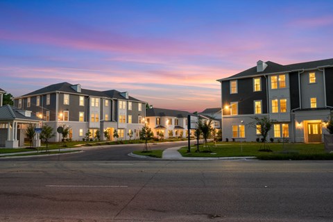 A large, well-lit building complex with multiple structures and a clear sky above.