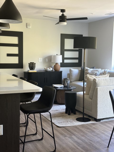 A black chair sits in front of a white counter.