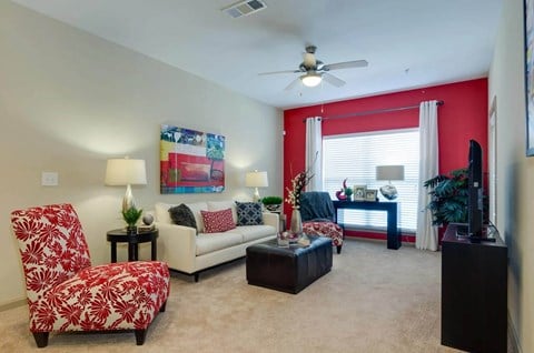 Carpeted living room with large windows at Ashley Auburn Pointe in Atlanta, GA