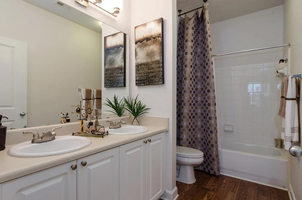 Large, modern bathroom with white tiles at Capitol Gateway in Atlanta, Georgia