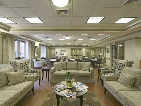 A living room with a couch, chairs, and a coffee table.
