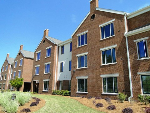 A large brick building with a white trimmed window.