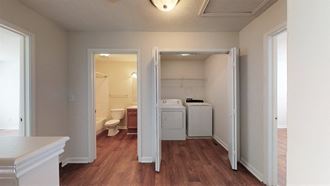 a renovated living room with a washer and dryer closet and a laundry room