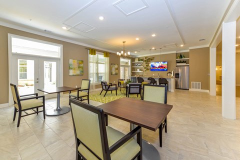 A dining room with a table and chairs.