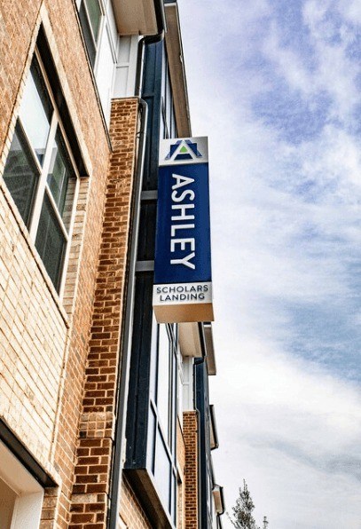 A sign for Ashley Solar Landing is displayed on a building.
