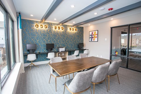 A conference room with a long table and chairs.