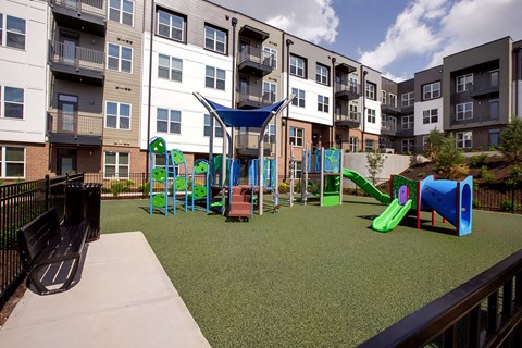A playground with a slide, swings, and a climbing frame.