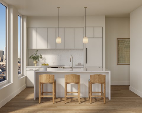A kitchen with white cabinets and a white countertop with two wooden barstools.