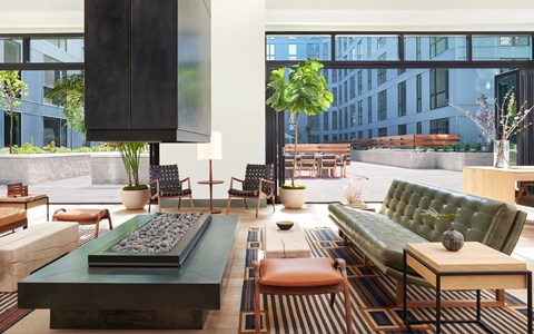 A modern living room with a green sofa and a wooden coffee table.