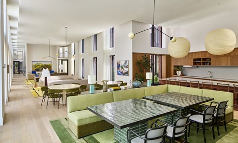 A modern dining room with a glass table and chairs.