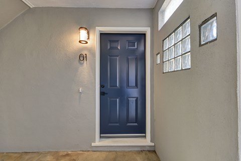 A blue door with a number 01 on the wall above it.