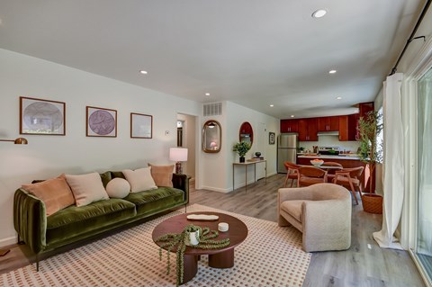 A living room with a green couch and a coffee table.