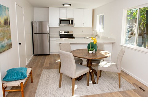 a kitchen and dining room with a table and chairs