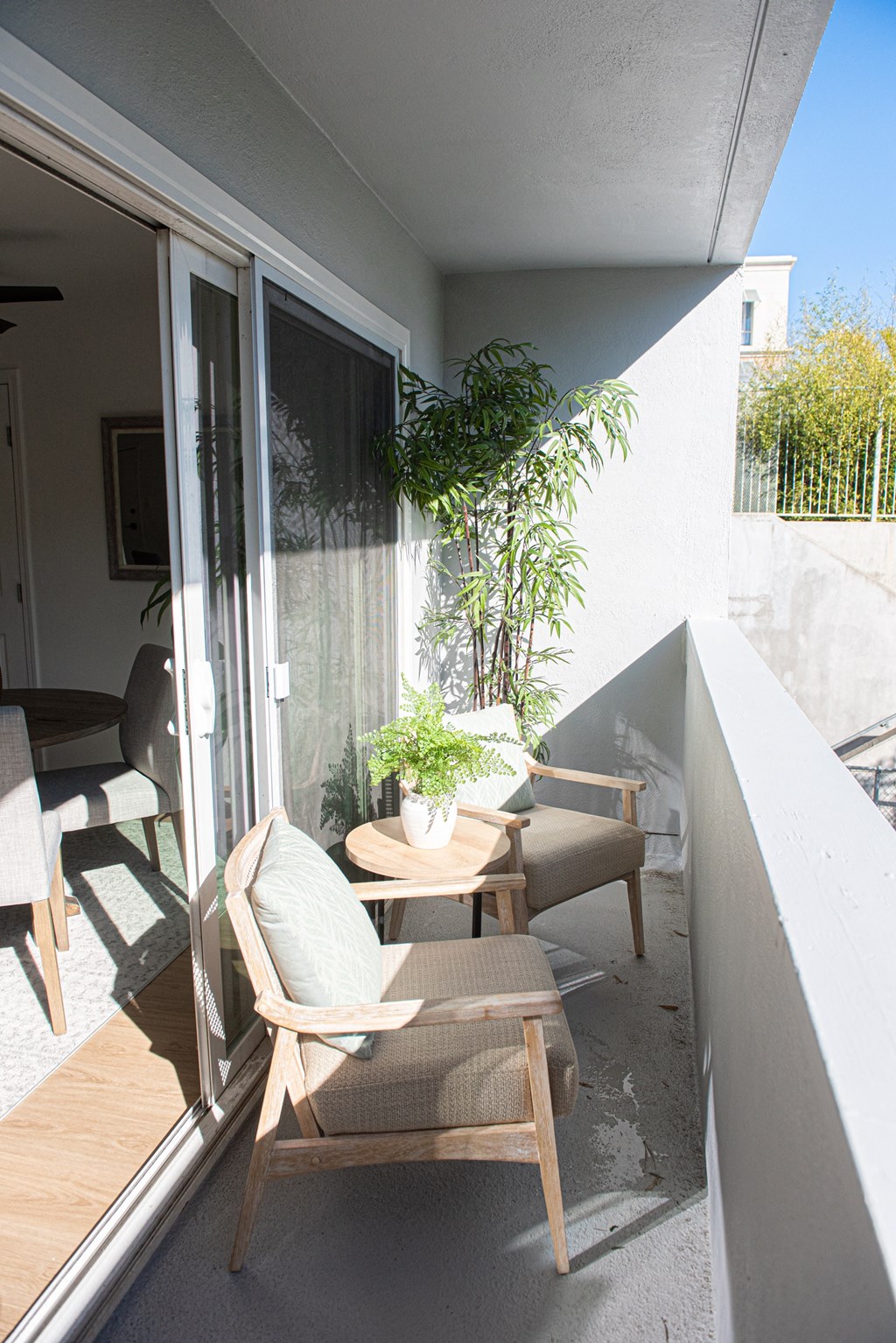a small balcony with two chairs and a table