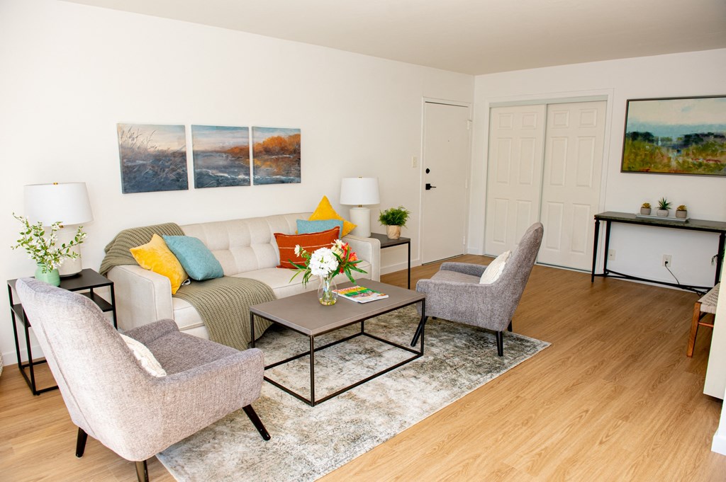 a living room with a couch and two chairs