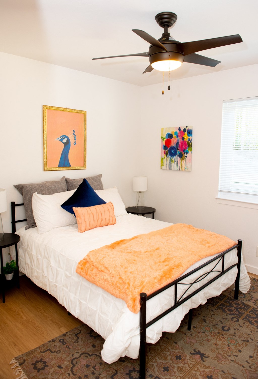 a bedroom with a bed and a ceiling fan