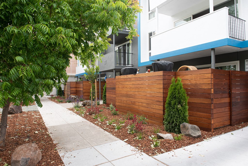 a wooden fence in front of an apartment building