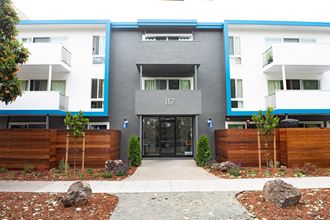 the front entrance of a modern apartment building
