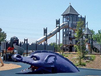 A playground with a slide and a play structure.