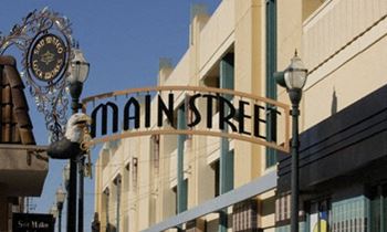 A street sign that says Main Street is in front of a building.