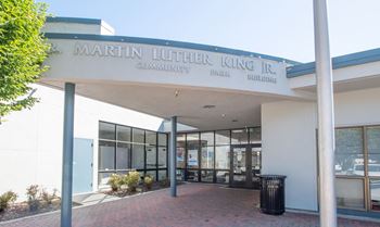 The front of Martin Luther King Jr. Community Building with a trash can in front.