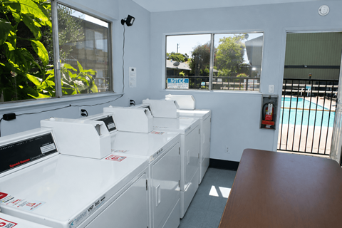 A room with a pool table and a pool table machine.