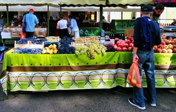 a man shopping at the fruit stand at the San Carlos Farmers' Market