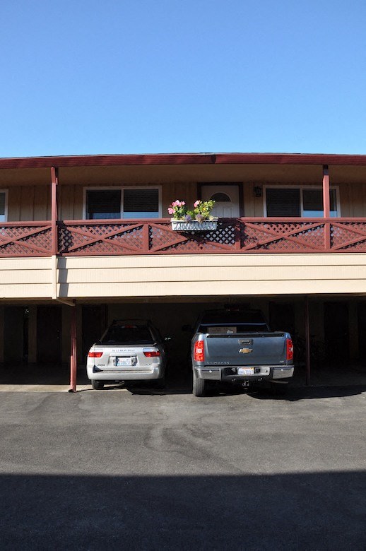 a parking lot with two cars in front of a building