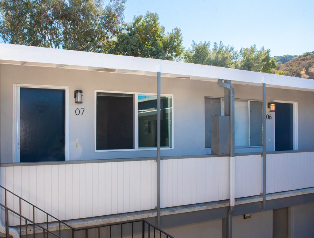the outside of a building with windows and a staircase