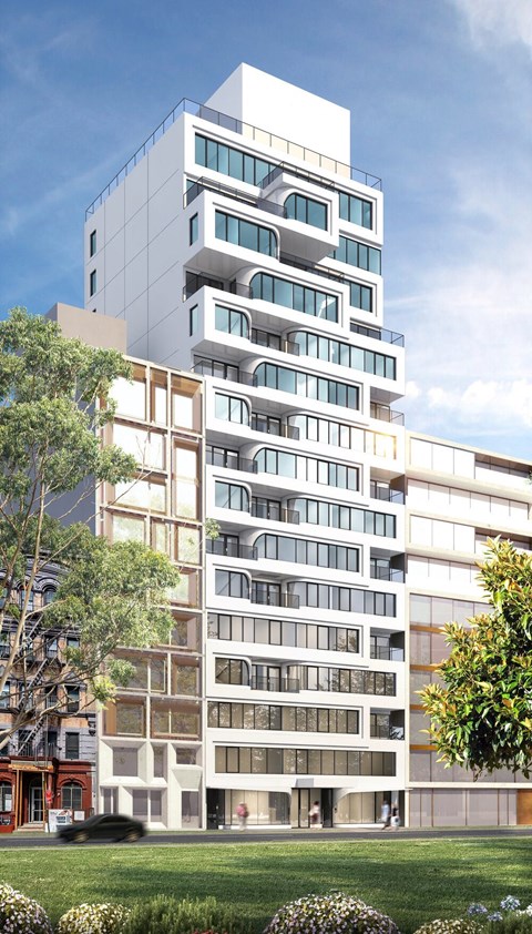 A modern multi-story building with balconies and large windows.