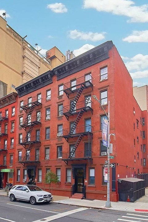 A red brick building with a fire escape on the side.