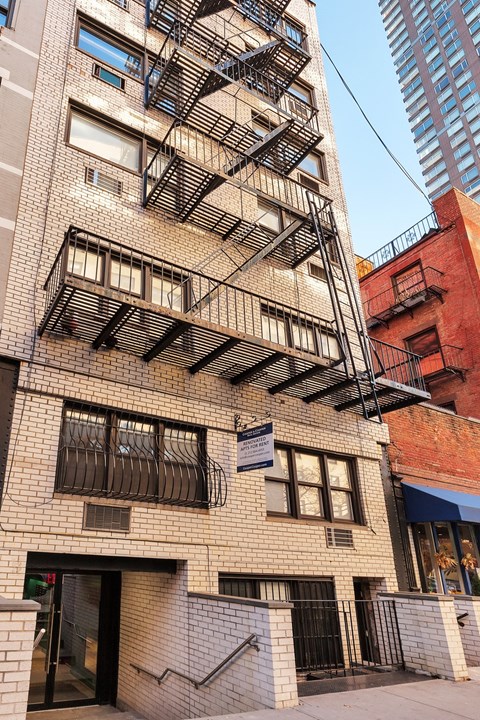 A tall building with a fire escape on the side.