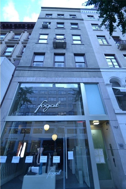 A tall building with a Fogal sign on the front.