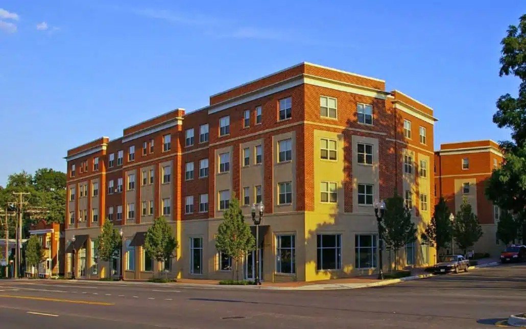 A large red brick building with a yellow trim.