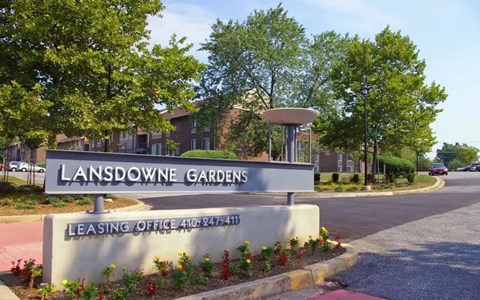 A sign for Lansdowne Gardens with a leasing office phone number.