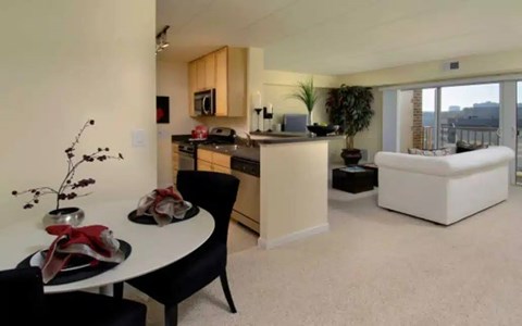 A modern kitchen with a dining table set for two.